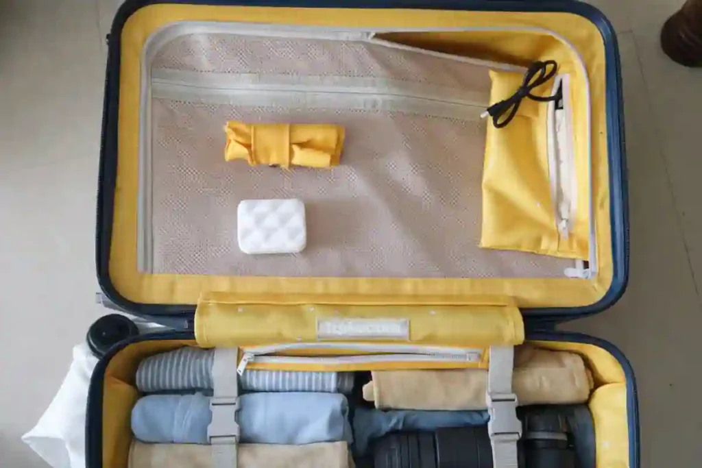 Inside view of Mokobara hard shell trolley luggage bag showing organized interior layout with compression straps, mesh divider, and zippered pockets for efficient packing