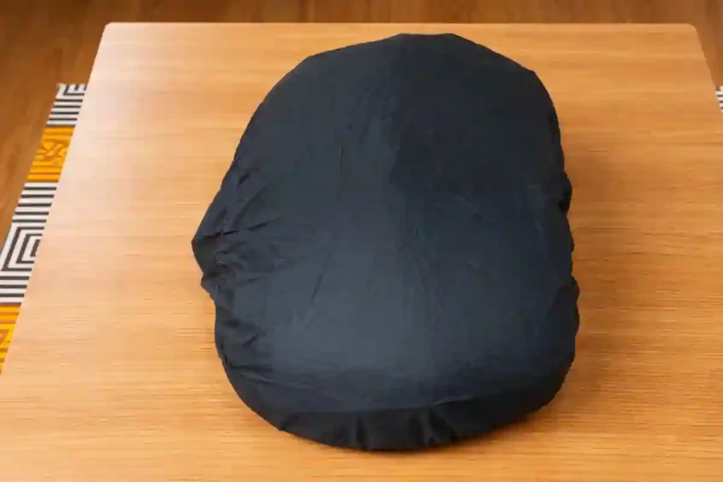 Safari Omega 35L backpack with neon rain cover protecting the bag during rain, showing water-resistant design for Indian monsoon