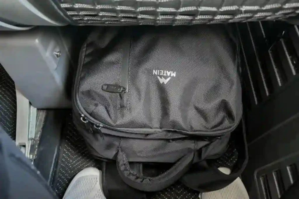 MATEIN travel backpack fitting under airplane seat showing personal item clearance